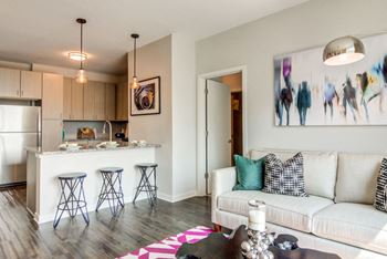 Space-saving island or breakfast bar with pendant lighting in most residences at Spoke Apartments in Atlanta, GA